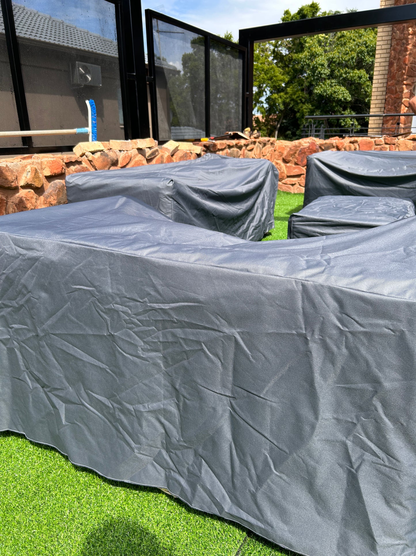 A set of grey weaterproof couch covers
