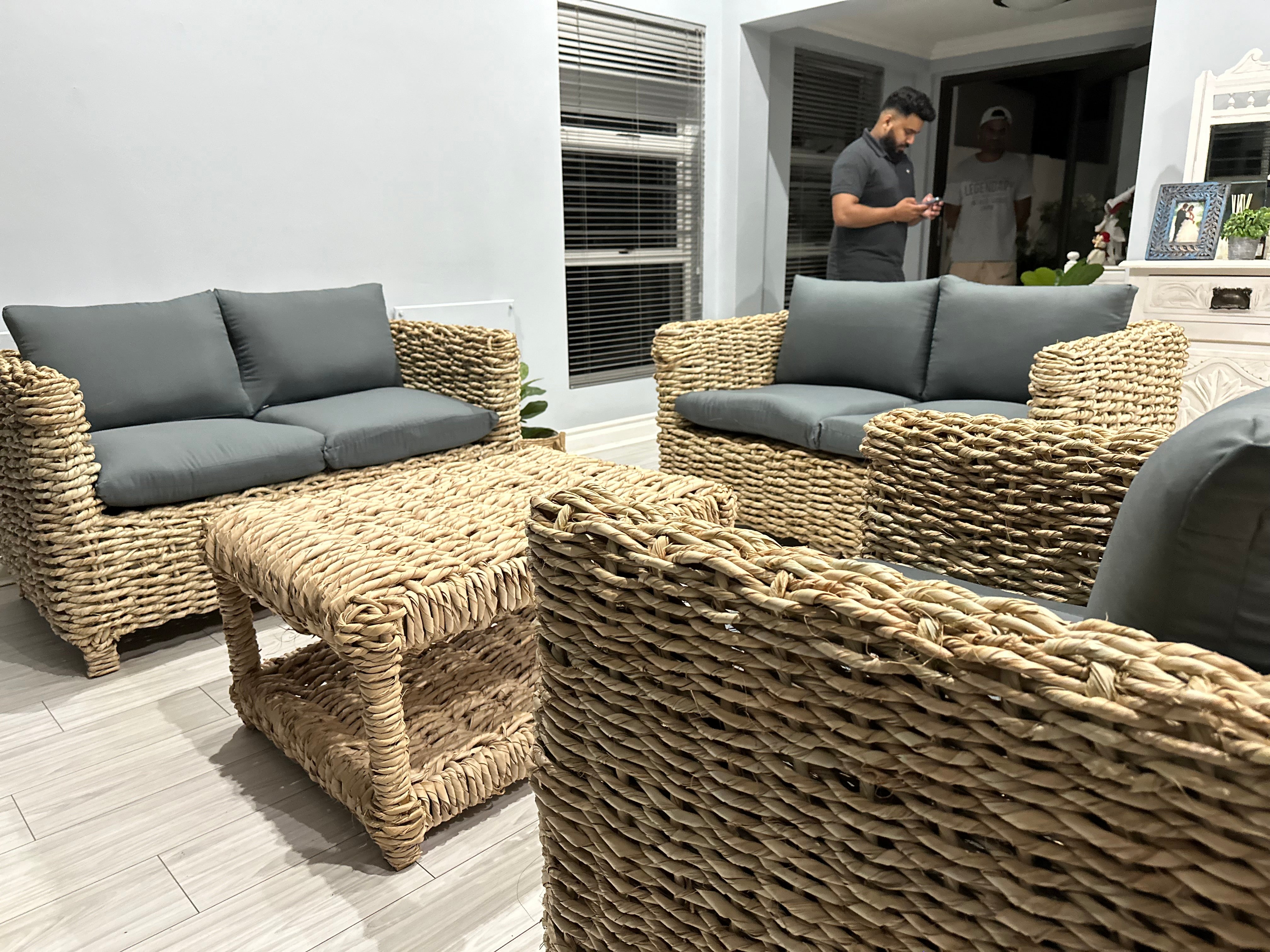 5 seater wicker lounge suite with grey cushions and a coffee table