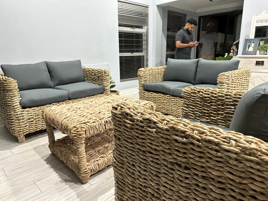 5 seater wicker lounge suite with grey cushions and a coffee table