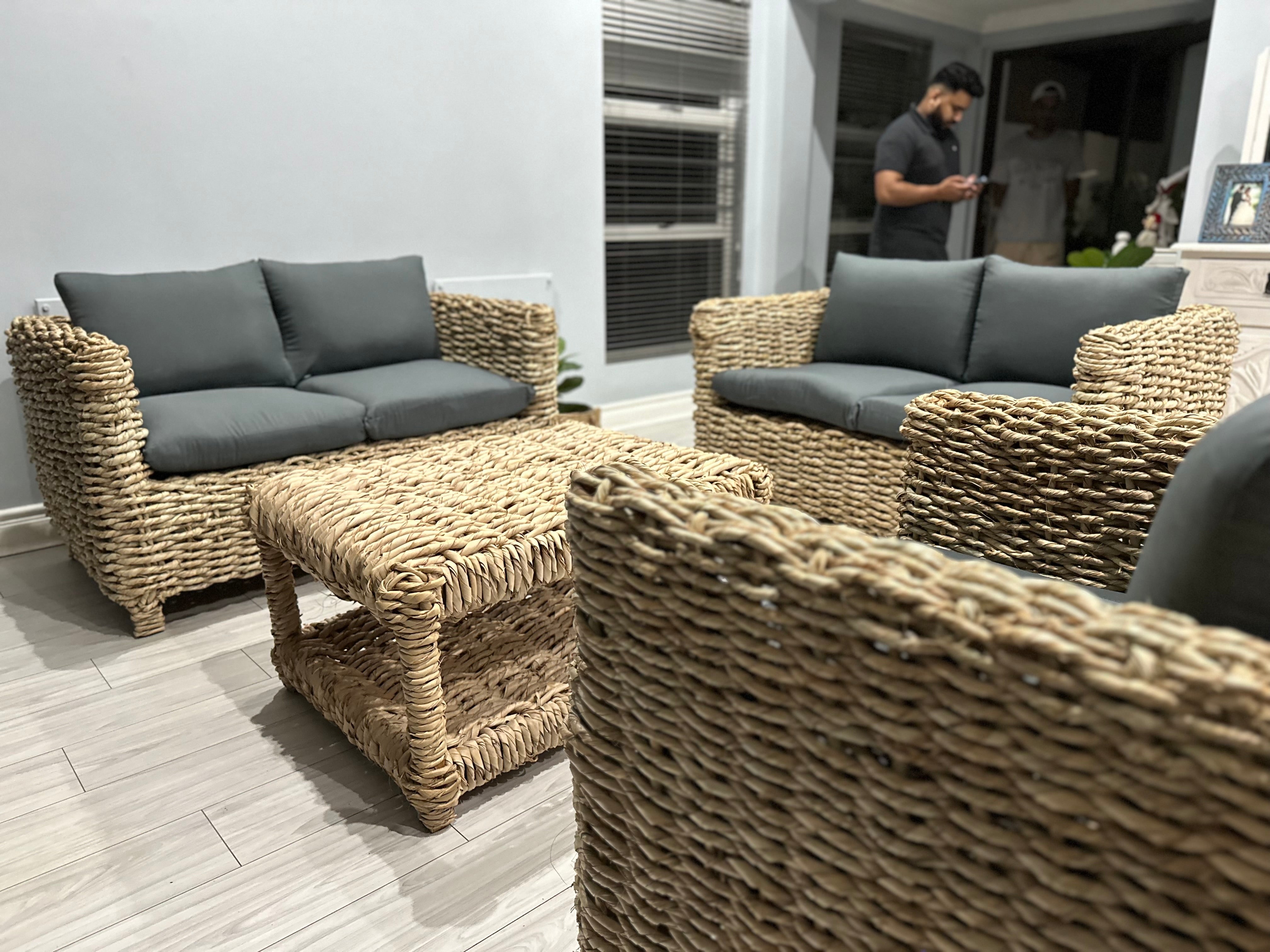 5 seater wicker lounge suite with grey cushions and a coffee table