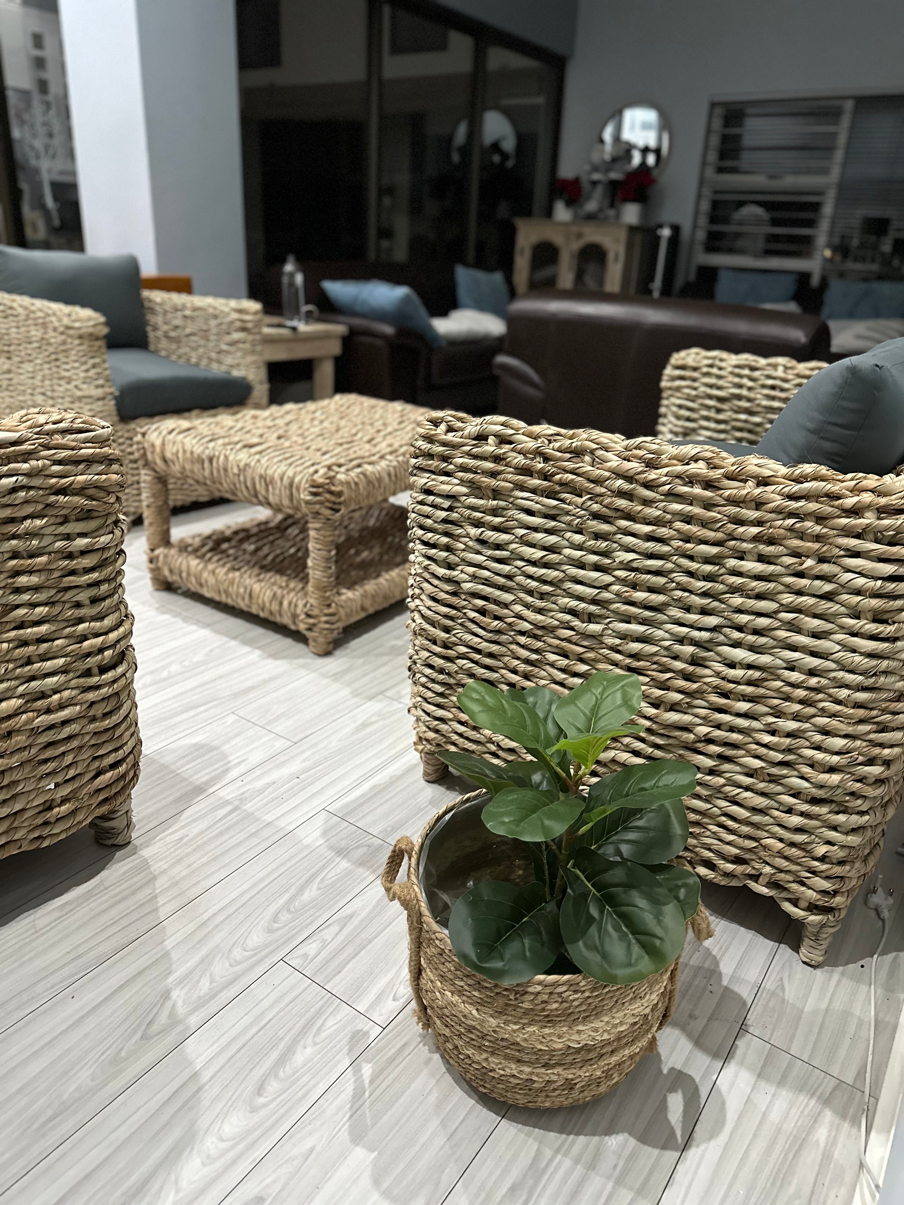 1-seater grey cushion wicker couch with other wicker couches nearby