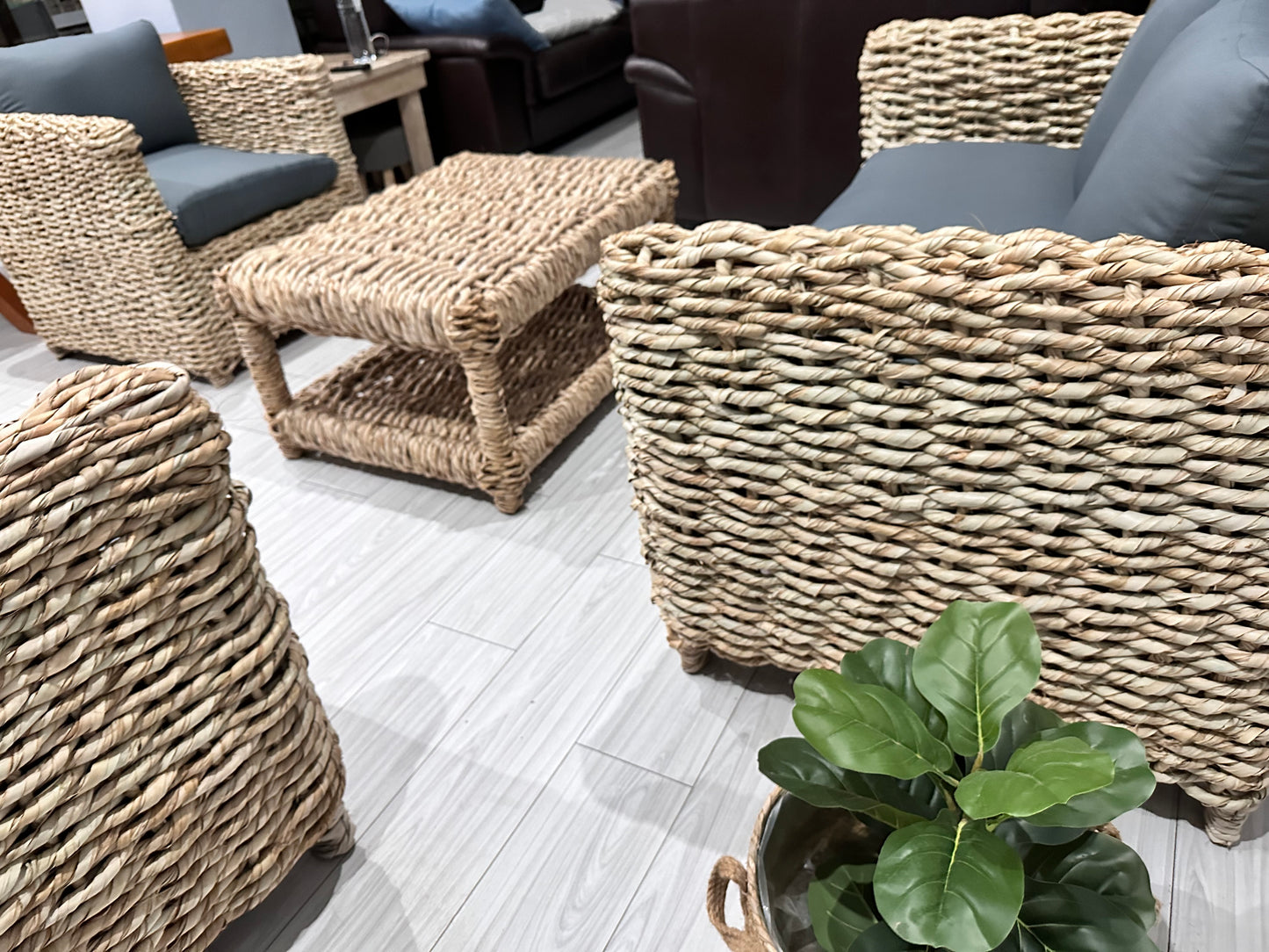 Grey cushion wicker couches with a coffee table