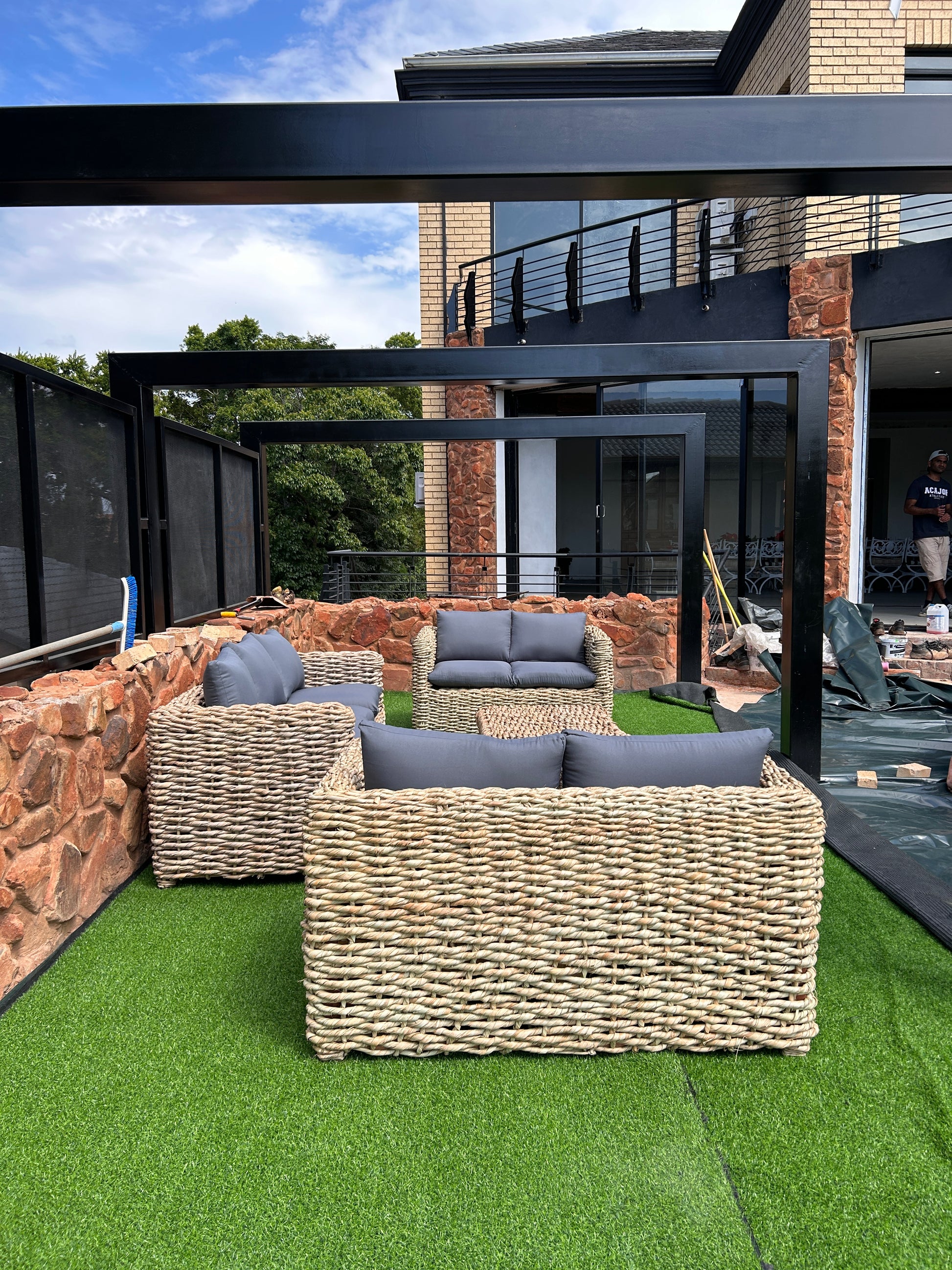 A 3-2-2 coffee table wicker lounge suite with grey cushions