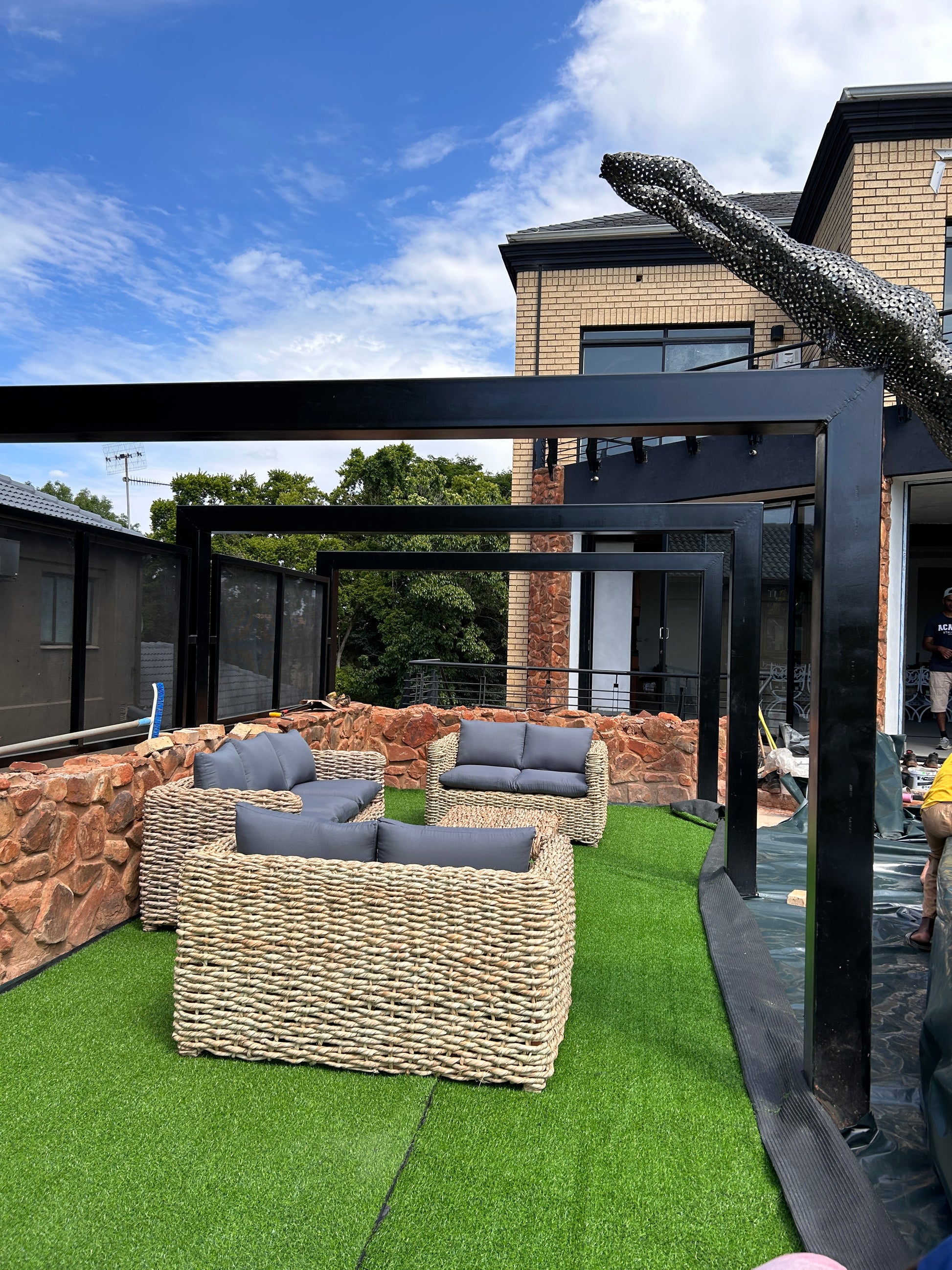 A 3-2-2 and coffee table wicker lounge suite with grey cushions