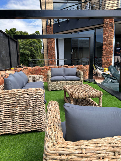 A 3-2-2 coffee table wicker lounge suite with grey cushions