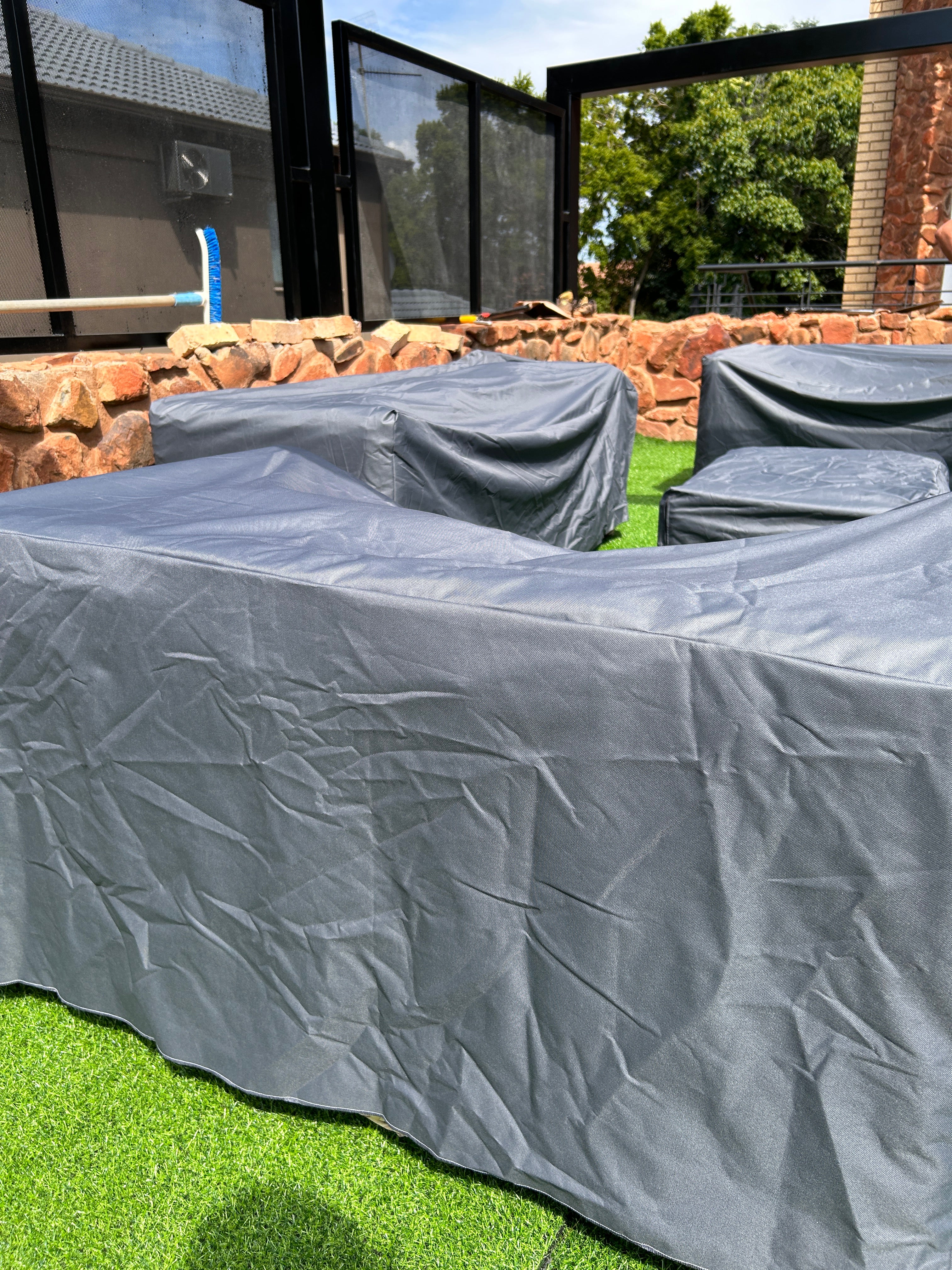 A set of grey weaterproof couch covers